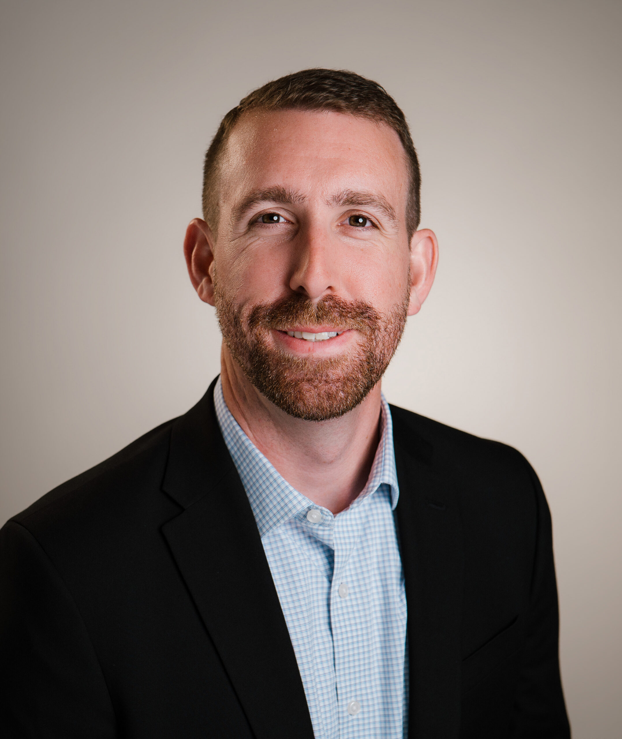 2 Corporate headshots in Newport Beach — professional studio portrait of a man in a navy suit.